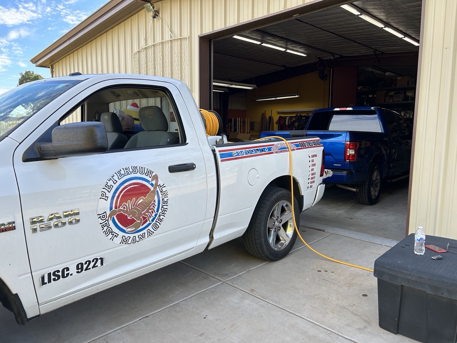 Peterson Pest Management truck with AZ Lic. 9221 lettering parked at the shop