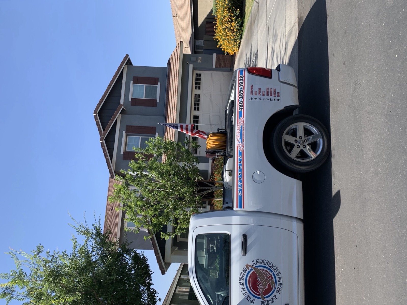 Peterson Pest Management truck parked in front of a Gilbert, Arizona home